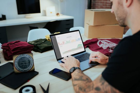 Man reviewing business charts and graphs on laptop